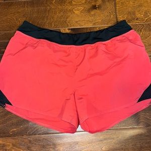 Red with black details woman’s Reebok speedwick shorts